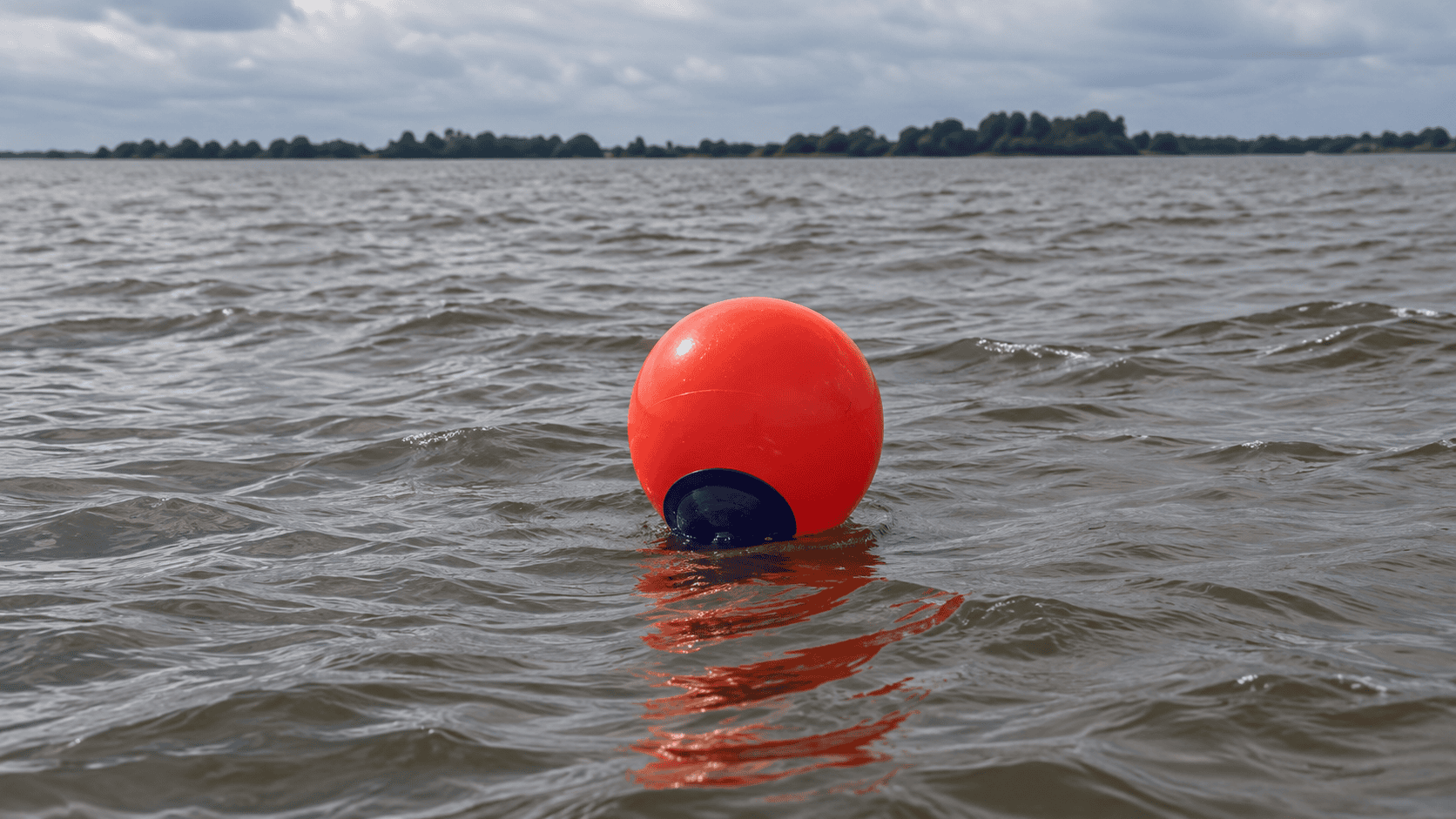 Enviro-USA red floating marker buoy deployed in open water to identify marine work zones, containment systems, turbidity curtains, and floating barriers.